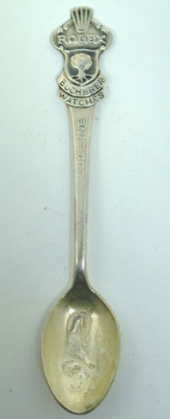 COLLECTORS "ROLEX" STERLING SPOON: RETAILED BY ROLEX BUCHERER, THE TOP OF THE SPOON IS ENGRAVED WITH A ROSE. IN THE BOWL IS THE DEPICTION OF THE LION MONUMENT OF LUCERNE. BACK OF THE SPOON IS MARKED B 100 12. 4.25" LONG. GREAT COLLECTO