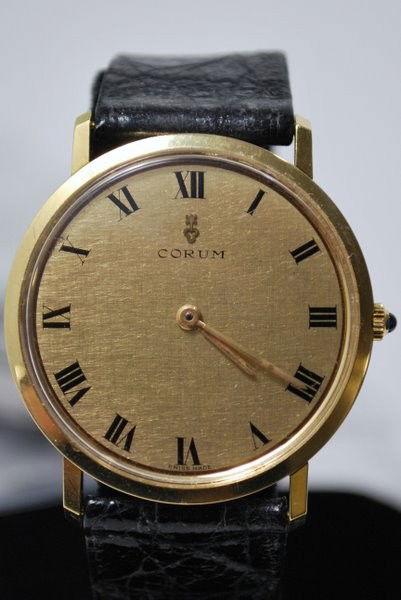 18KT CORUM MANUAL MVT: CIRCA 1980'S ROMAN NUMERAL DIAL.33MM CASE W/O CROWN