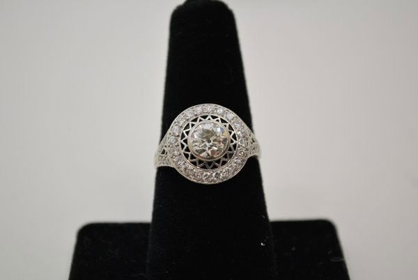 PLATINUM ART DECO STYLE 1.85CT DIAMOND RING: SET WITH APPROX. 1.25CT CENTER EUROPEAN CUT L-M COLOT SI QUALITY DIAMOND PLUS ACCENT DIAMOND BEZEL APPROX. .65CT TWT 7.2 GRAMS SIZE 6.25