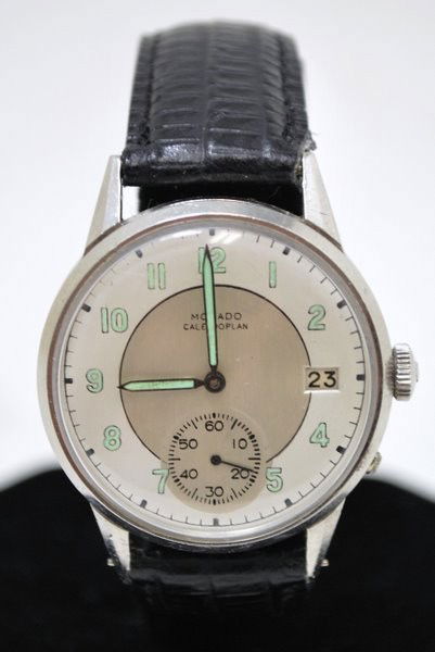 MENS S/S MOVADO CALENDERPLAN: CIRCA 1940S
