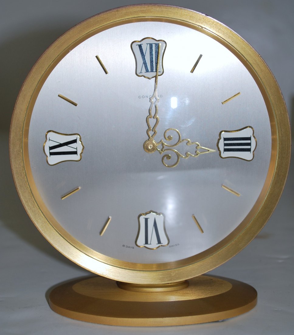 CONCORD DESK CLOCK: GOLD TONED CONCORD DESK CLOCK SOLD AS IS. POSSIBLY NEEDS NEW SPRING.