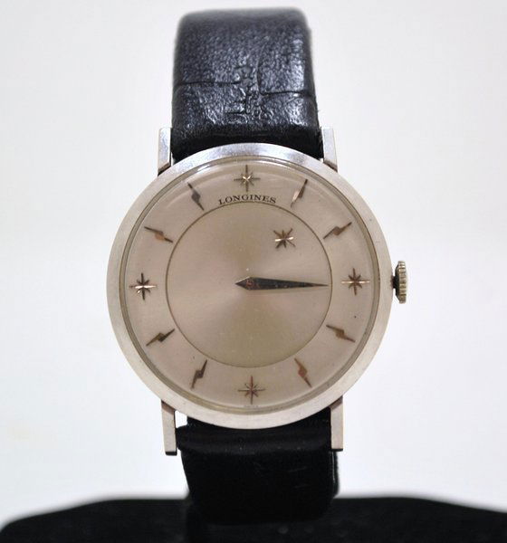 14KT W.G. LONGINES MYSTERY DIAL WATCH: CIRCA 1950'S HAS LIGHTNING BOLT MARKERS WITH STARS AT 12, 3, 6 AND 9 A STAR ALSO REPLACES THE HOUR HAND, GREAT LOOKING WATCH.