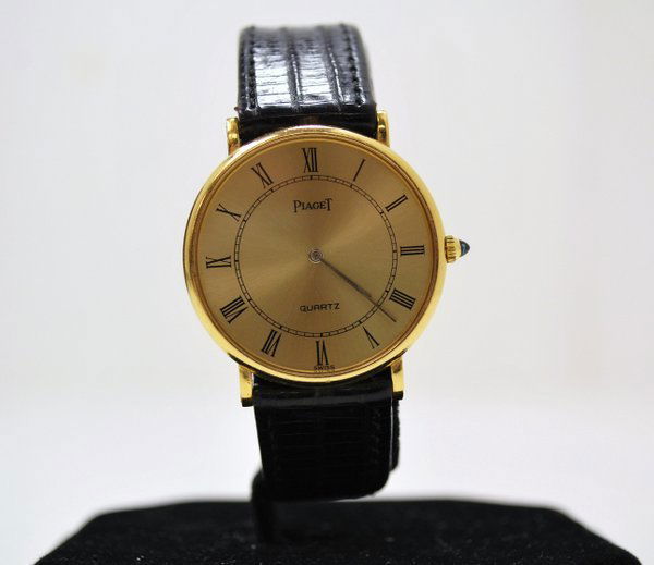 PIAGET 18KT ROUND WRISTWATCH: CIRCA 1980S ROMAN NUMERAL DIAL, PIAGET SWISS QUARTZ MVT.