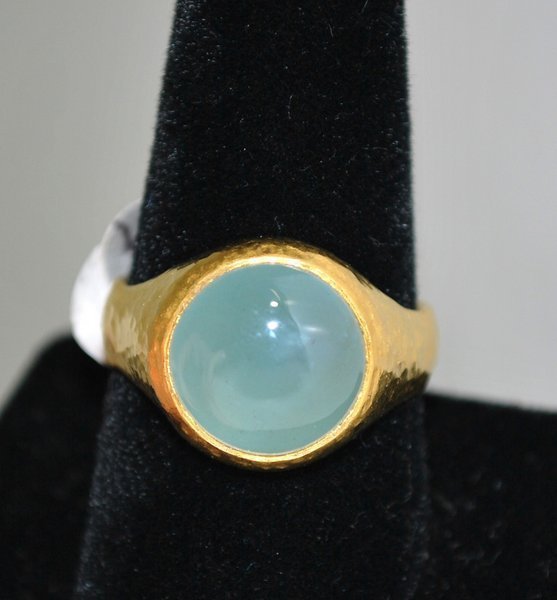 24KT Y.G. DESIGNER RING BY GURHAN W/AQUAMARINE: HAND MADE HAMMER DESIGN SET WITH CABACHON CUT AQUAMARINE SIGNED AND NUMBERED INSIDE SHANK RETAILED BY NIEMAN MARCUS TWT 12.4 GRAMS SIZE 8.75