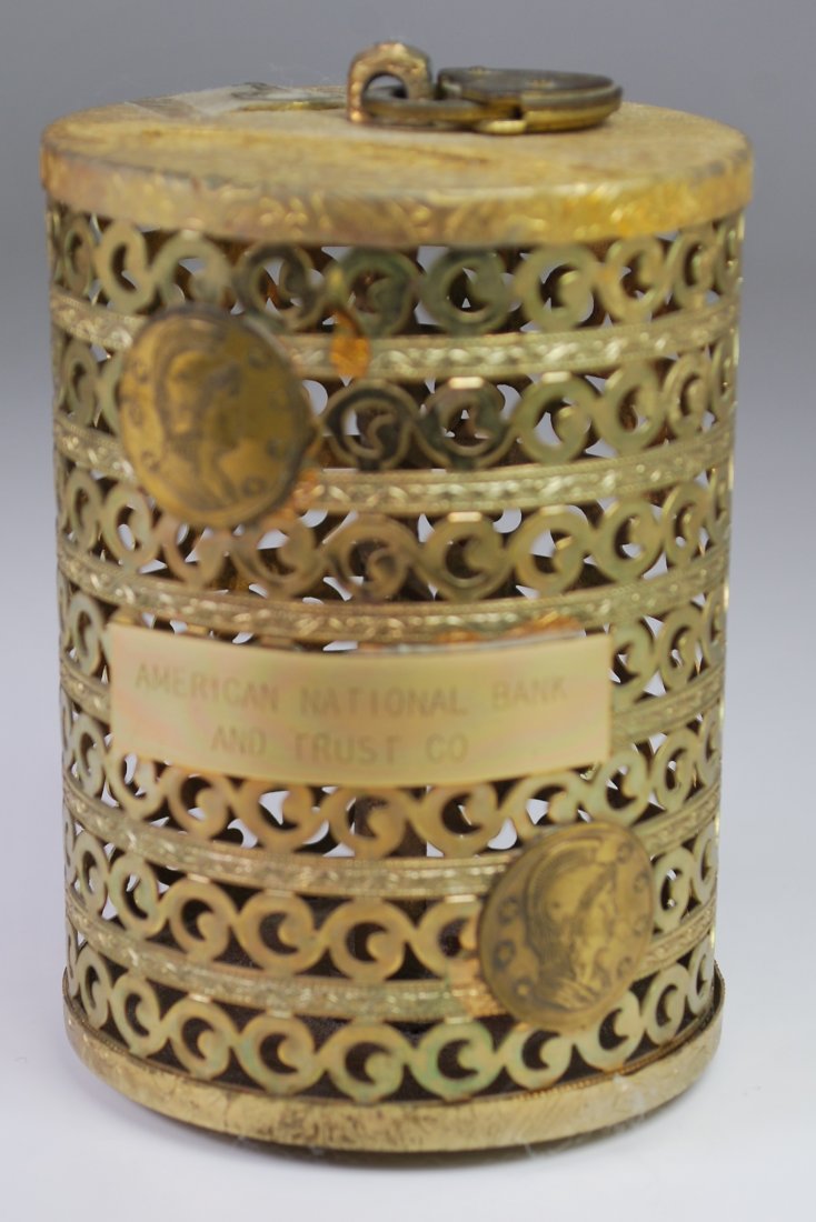 ANTIQUE BRASS BANK: ANTIQUE BRASS CAGE STYLE COIN BANK. MARKED WITH PLAQUE "AMERICAN NATIONAL BANK AND TRUST CO." 4" X 3" DIAMETER.