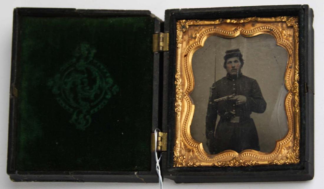 1/6th plate tintype Private George F Morris Co K 5th VT: 1/6th plate tintype of Private George F. Morris armed with rifled musket and two revolvers, Detailed as a sharpshooter and re enlisted as Veteran Volunteer, in seated liberty thermoplastic case with r