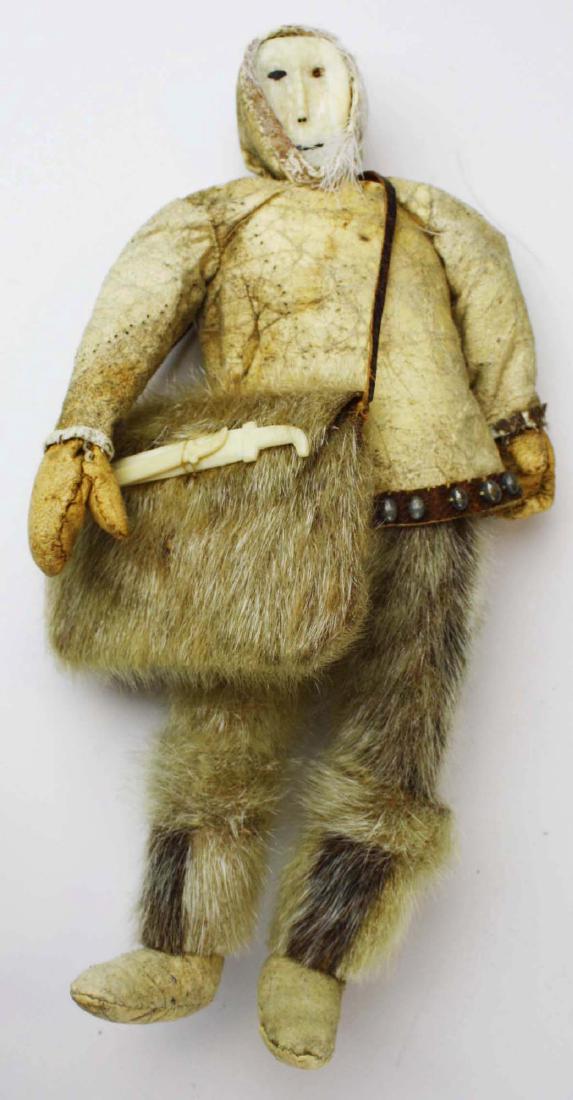 early 20th c Inuit hide & sealskin doll: early 20th c Inuit/ Eskimo/ First Nations hide & sealskin doll, carved bone face, decorated w/ metal beads, ht 10 1/2"