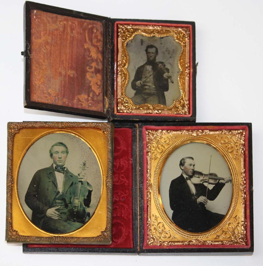 three Ambrotypes of fiddlers: two sixth plate images and one ninth plate occupational image two in leather cases. All musicians with violins.