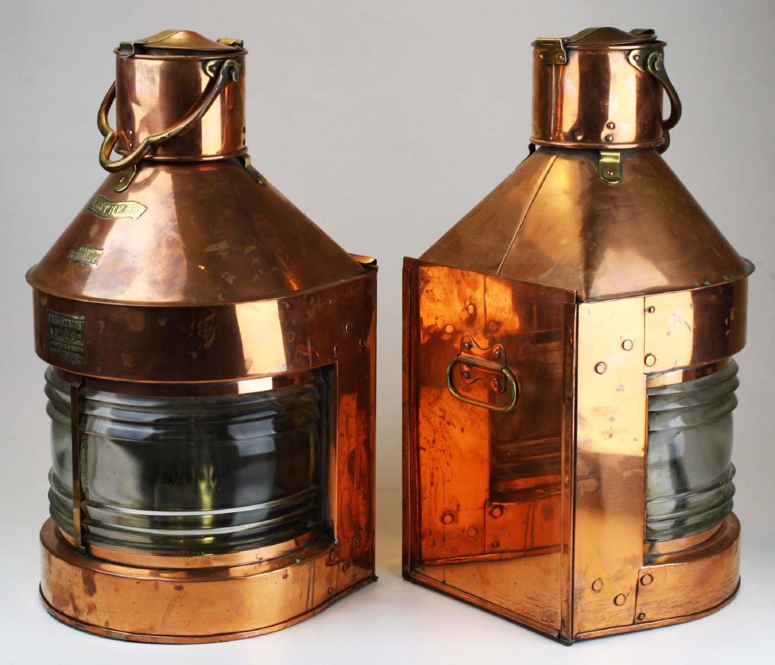 Pair of 19th c copper Masthead ship lanterns: Pair of outstanding 19th c copper and brass Masthead ship lanterns. Each with its original oil lamp slide in burner with reflectors. Swing handles. 22" high. Very good condition.