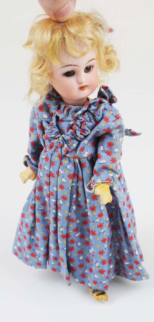Kammer & Reinhardt "walker" child doll: Kammer & Reinhardt "walker" child doll (head turns from side to side as she walks), bisque socket head, sleep eyes, jointed composition body, slightly damaged fingers, ht 8"