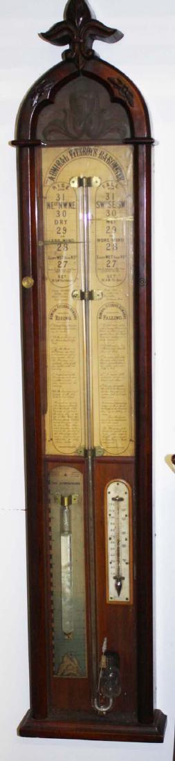 Admiral Fitzroy's Barometer in Gothic case: Admiral Fitzroy's Barometer in carved walnut Gothic case with lithographed paper scales and thermometer 46" x 8.5" x 3"-fluid missing from barometer