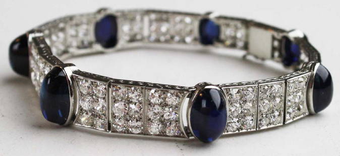 White gold, diamond, & sapphire bracelet: 14k white gold, diamond, and natural sapphire bracelet. 7 Cabechon sapphires bezel set, (2) (8mm x 5.5mm x 3mm) 1/2 ct, (2) (9mm x 6mm x 3mm) 3/4 ct, (2) (9mm x 6.5mm x4mm) 1 ct, and (1) (11mm x 7 mm