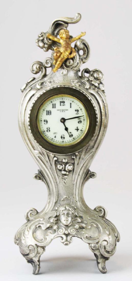 ca 1900 New Haven silver gilt boudoir clock: ca 1900 New Haven Clock Company silver gilt boudoir clock w/ putti surmount, ht 10 1/4", not running