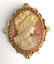 14 k yellow gold ornate cameo brooch.