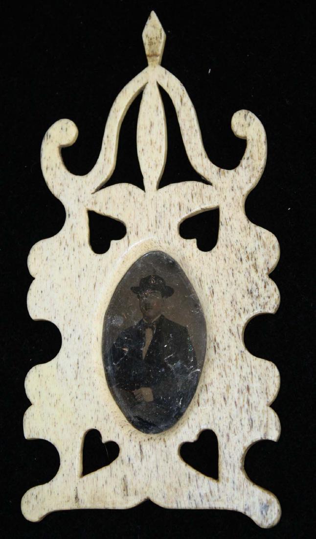 mid 19th c scrimshaw framed tintype: mid 19th c scrimshaw tintype in carved whale bone frame w/ heart shaped cut-outs, isinglass (mica) used instead of glass over tintype, 7" x 3 1/2"