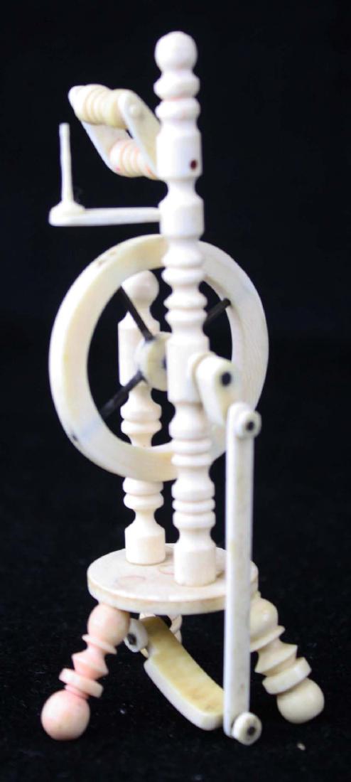 mid 19th c scrimshaw miniature spinning wheel: mid 19th c scrimshaw carved whale bone miniature spinning wheel, fully functional, ht 4 3/4"