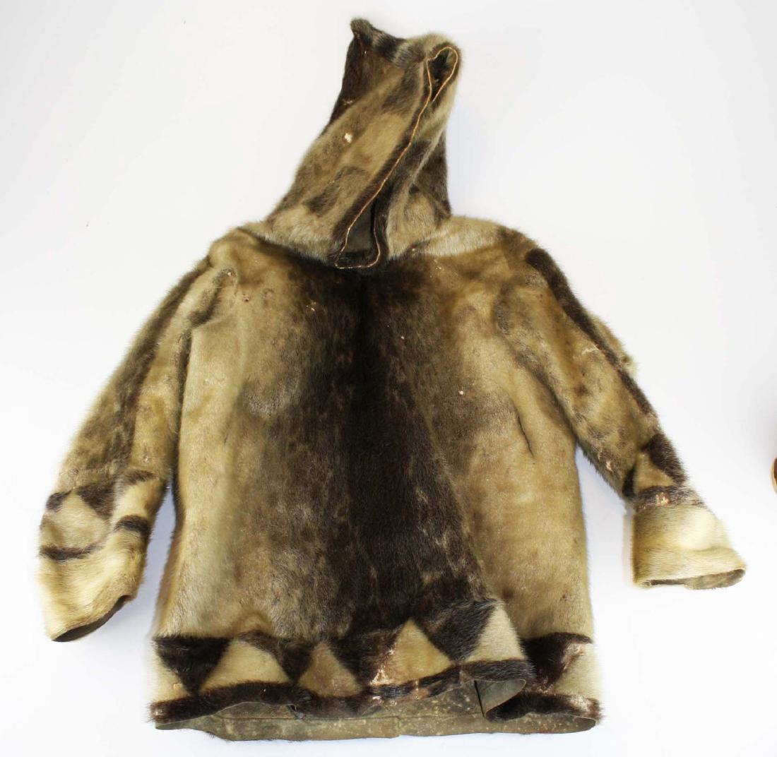 early 20th c Inuit child's sealskin parka: early 20th c Inuit child's sealskin parka w/ peaked hood, pieced quilted decorative lower edge, ht 36", overall fur losses