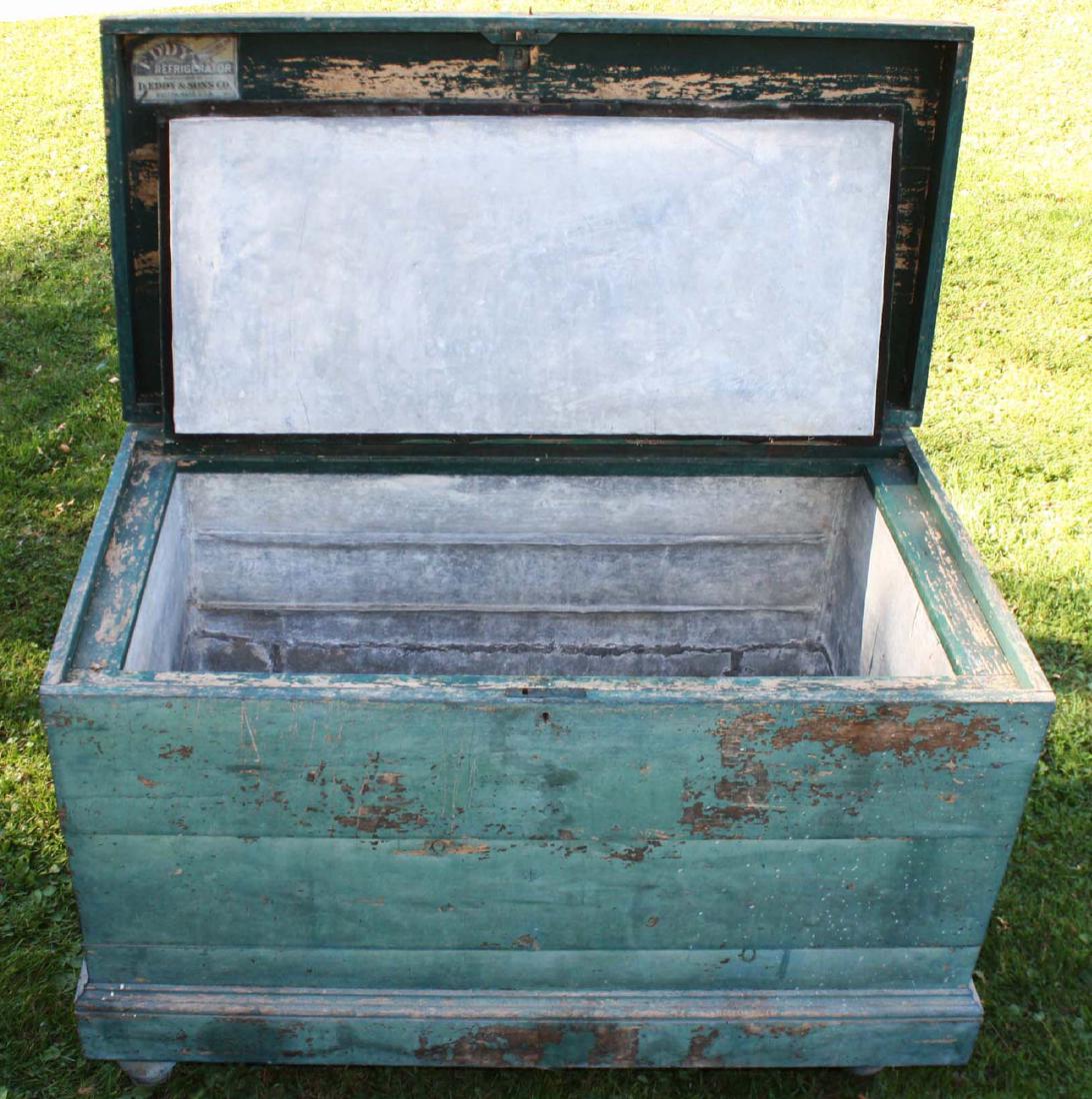 Eddy and Sons-Eddy Refridgerator: late 19th c Eddy and sons refridgerator/ ice box in old green surface- retaining original paper label and tin lining- reasonable signs of age and one loose foot 36"h x 46"l x 26"d