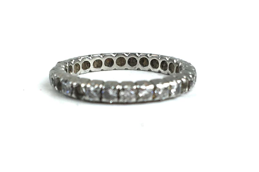 Platimum and diamond wedding band.: Platinum and diamond wedding band with surrounding diamonds .03 rd cut diamonds, missing 4 stones. Ring size 5.5
