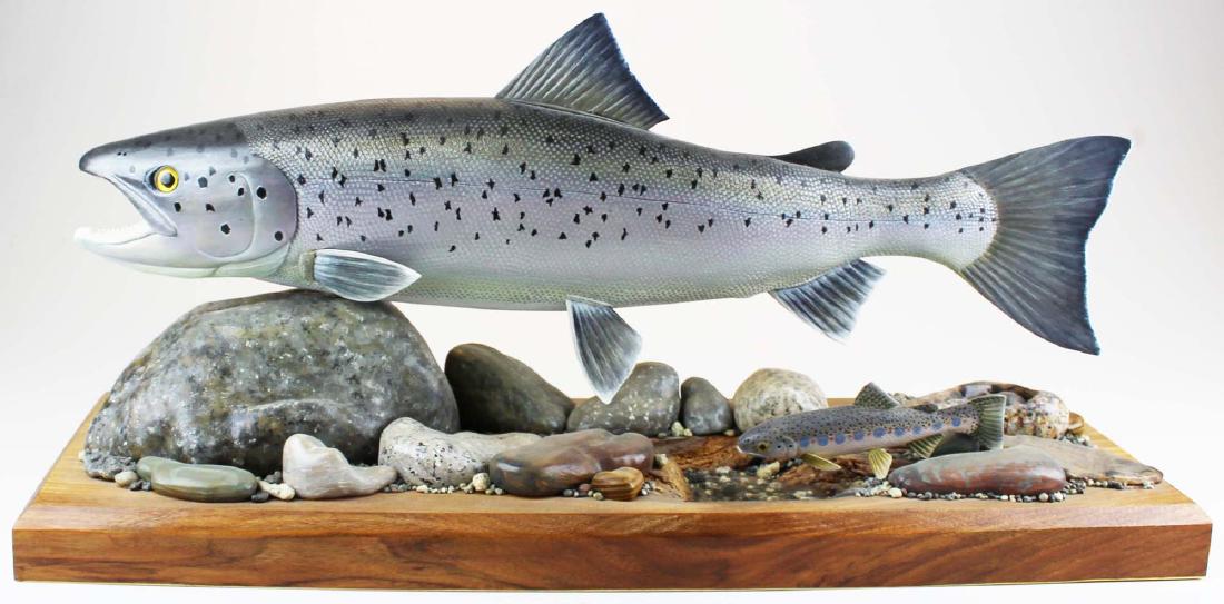 Albert Diem life size full body salmon carving: Fine Albert Diem life size full body salmon carving with small rainbow below. 24" long salmon, 6" long rainbow mounted above river stone platform.