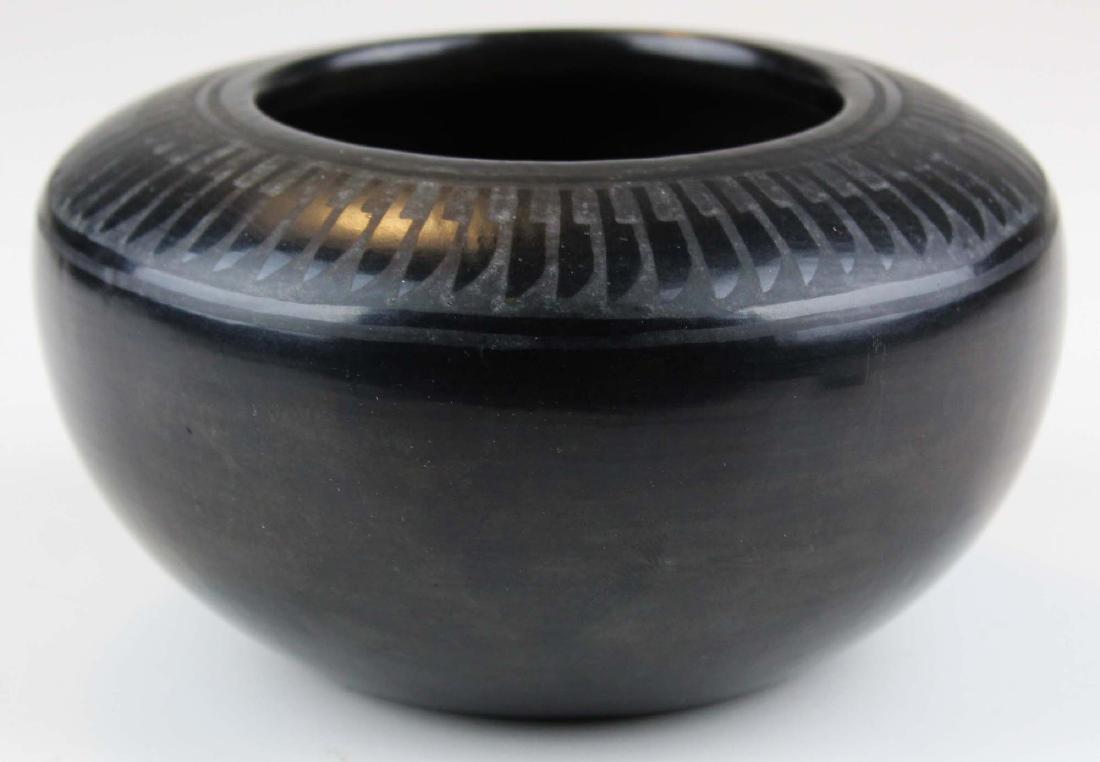 early 20th c F Naranjo San Ildefonso pot: mid 20th c Florence Narajo San Ildefonso Pueblo pottery jar with feather design, diameter 6 1/2"