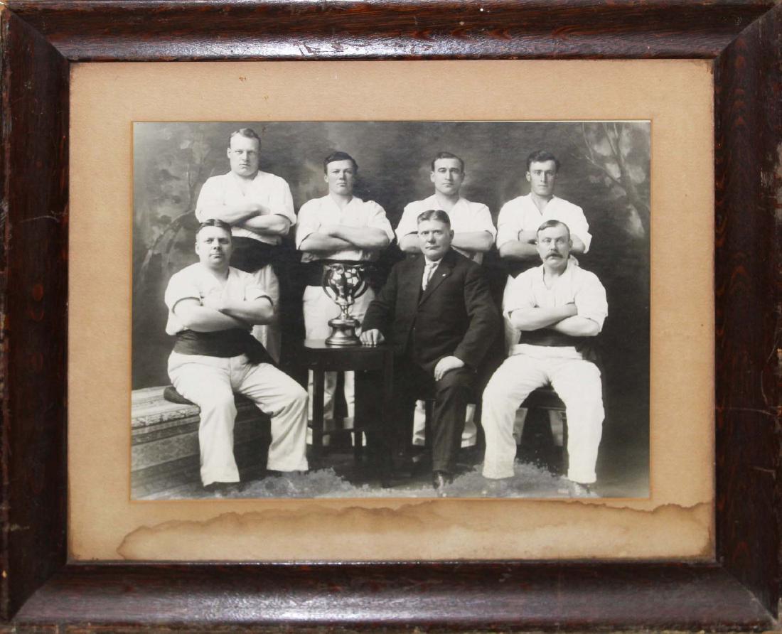 ca. 1900 large format wrestling team photograph: ca. 1900 large format wrestling team photograph featuring stag handled trophy cup, in original quartersawn oak frame 19.5" x 23" -water damage to matte and edge of photograph