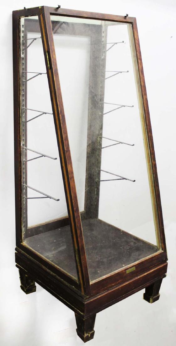 slant front 5 tier country store display case: 1920's stained birch slant front country store display case, 5 glass interior shelves with stamped brass makers label "The Columbus Show Case Company Columbus, Ohio" 60.5" x 23" x 24" -traces of strip