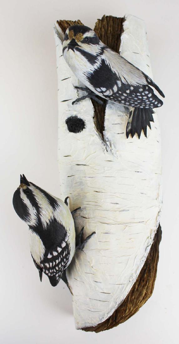 Two carved & painted song birds on birch log: Two life size carved and paint decorated song birds mounted to a paint decorated birch log. 15" long.