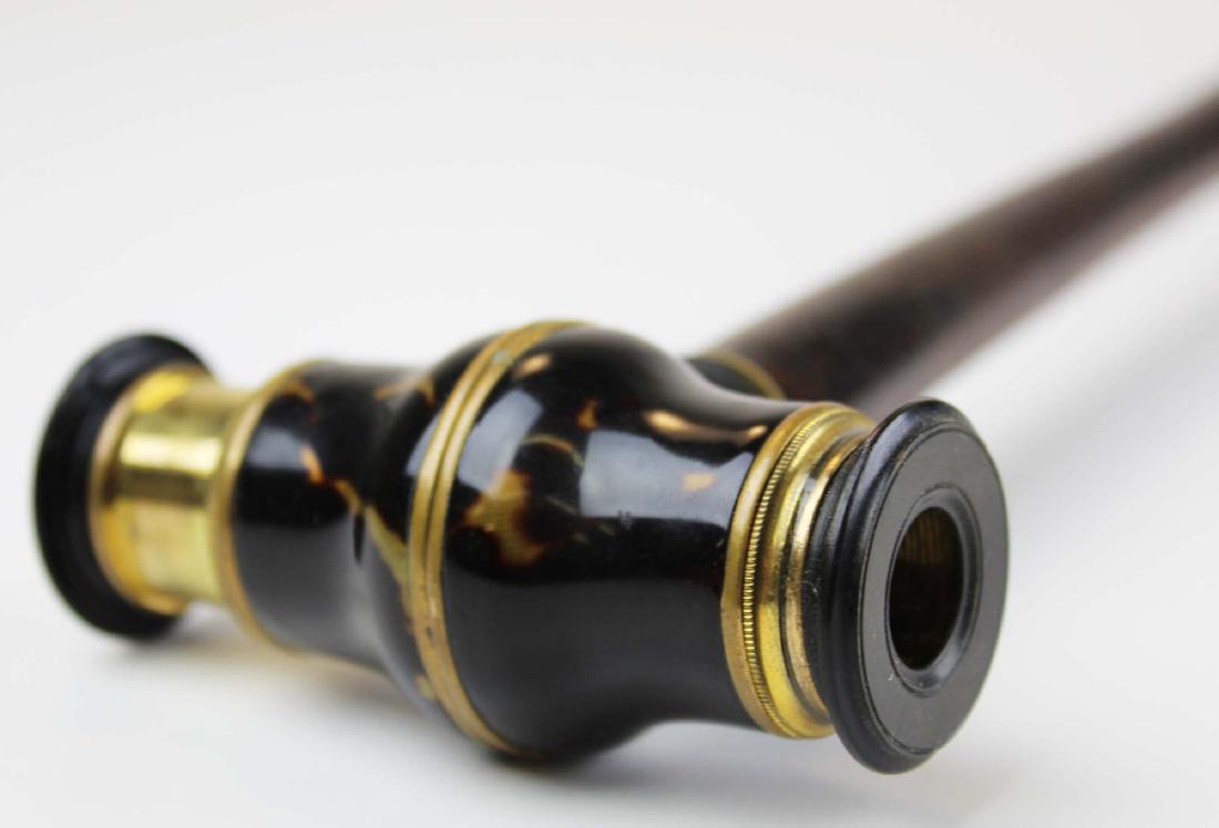 19th c Metamorphic telescope cane: 19th c Metamorphic telescope cane having a tortoise shell & brass mounted telescope cane with singular extension on a twist cane. Gutta percha end caps. One with crack.