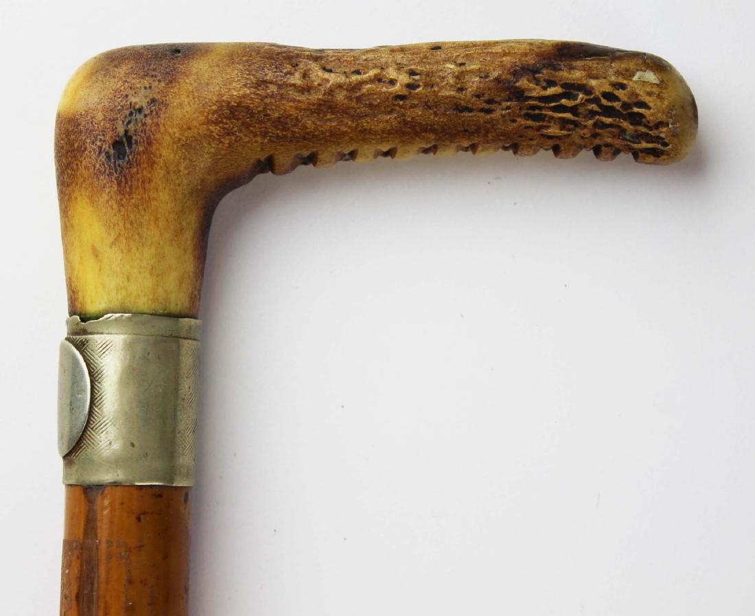 Sword cane: Early 20th c sword cane with stag horn grip, bamboo case and 14 inch steel blade.