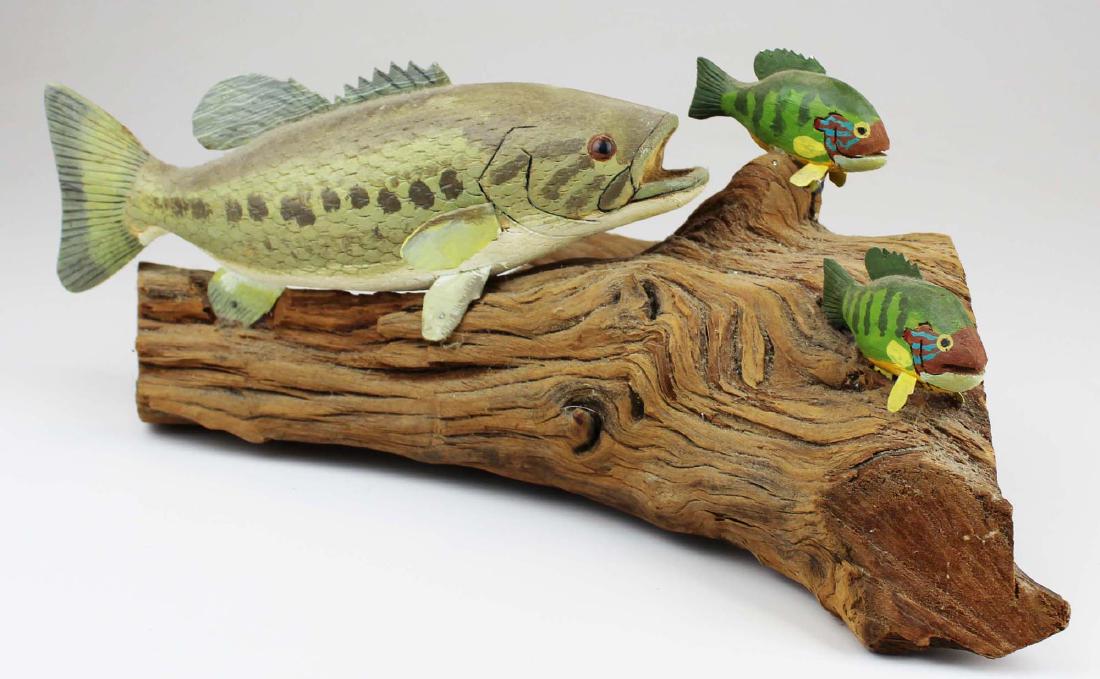 Rupert King Jr carving of bass chasing sunfish.: Rupert King Jr folk art carving of a bass chasing small sun fish. 16" long.