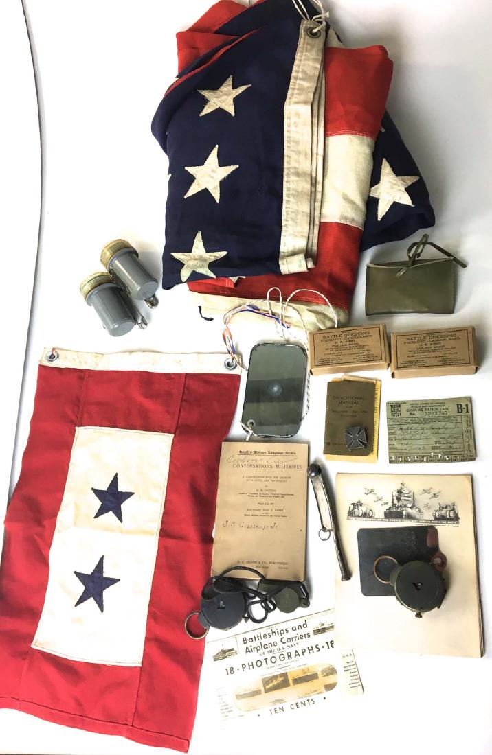 A group of WW II accessories and flags: A group of WW II accessories and flags including family service star flag (two stars), US WWII era flag, compass, whistle, battle dressing in orig US Army boxes, lights, cards.