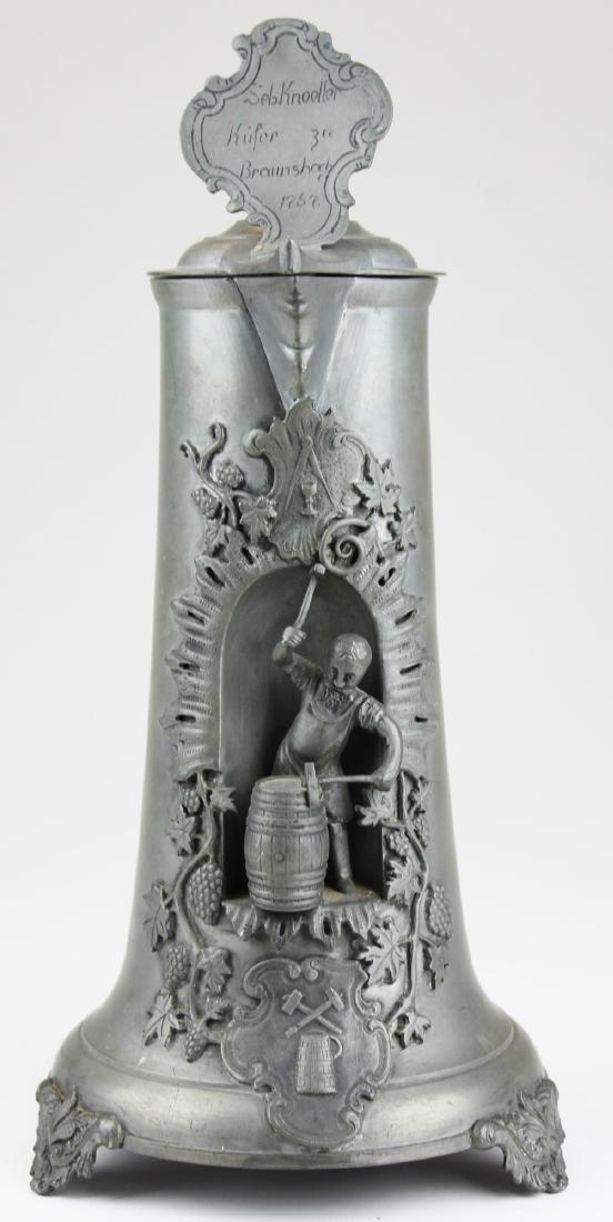 Replica 1757 German Rococo pewter flagon: Replica 1757 German rococo pewter wine flagon with figural cartouche inset of cooper forging wine barrel 14" x 6"