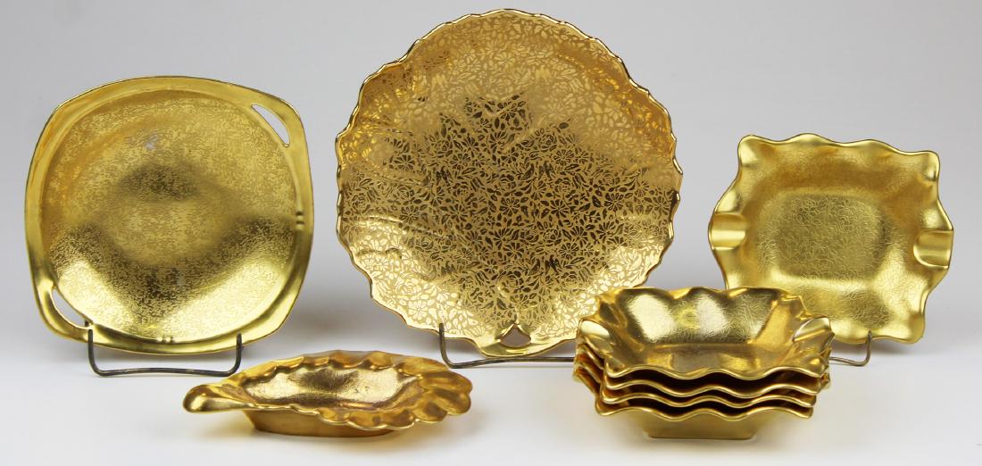 8 AOG Gold Engraved small porcelain dishes: 8 All Over Gold (AOG) Gold Engraved small porcelain dishes including 5 Pickard Rose and Daisy design ashtrays 1938-present mark, Pickard Gold Encrusted handled dish with 1912-1918 mark, Stouffer shell