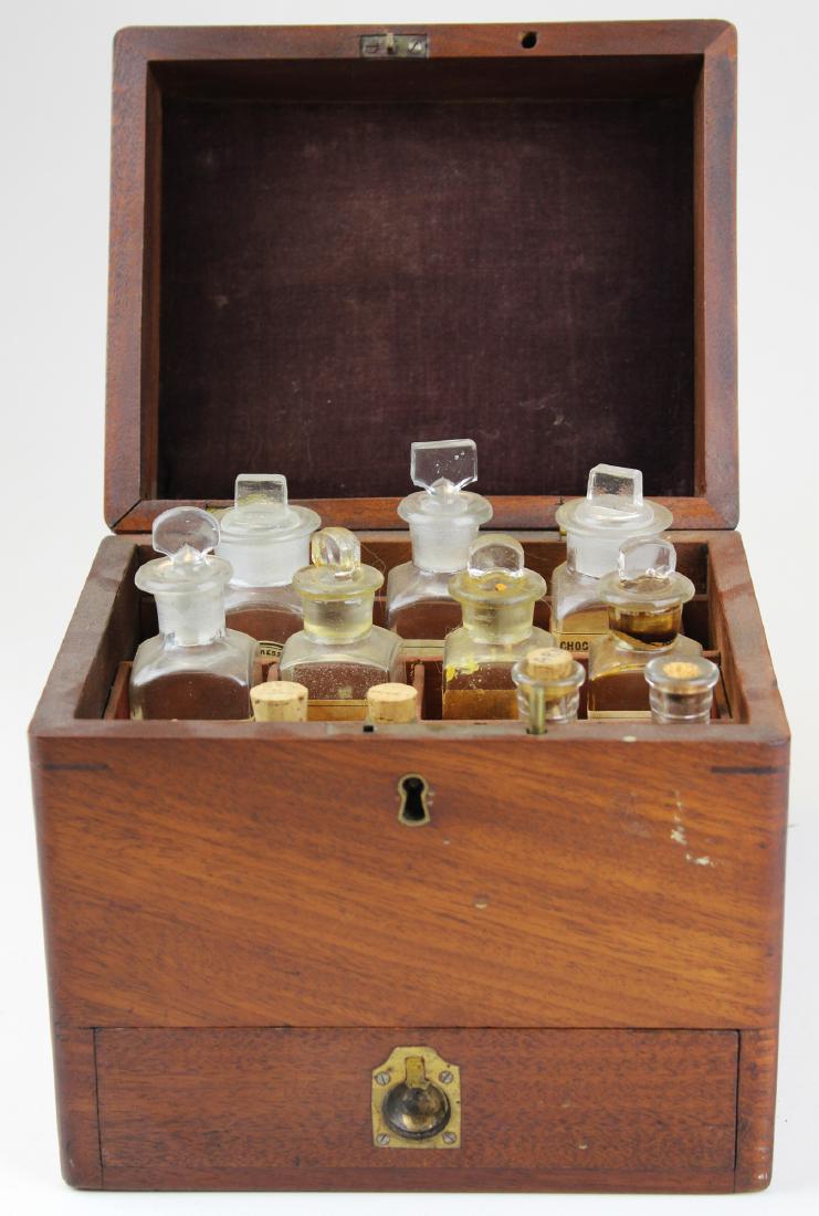 19th c walnut Pharmaceutical drug case: 19th c walnut lift top one drawer Pharmaceutical apothicary drug case. Velvet pad top Interior with a 12 bottle divided section. Lower drawer with 8 wood pill bottles. 8" x 8" x 8".