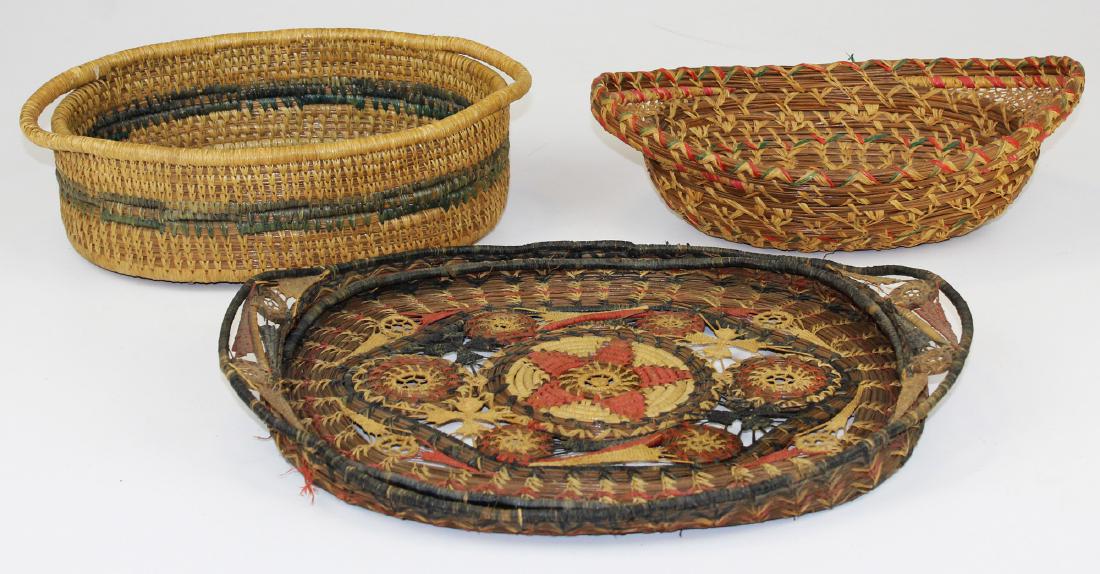 20th c Native American pine needle baskets: three early 20th c Native American pine needle baskets including Coushatta tray basket, diameters 11" to 15"