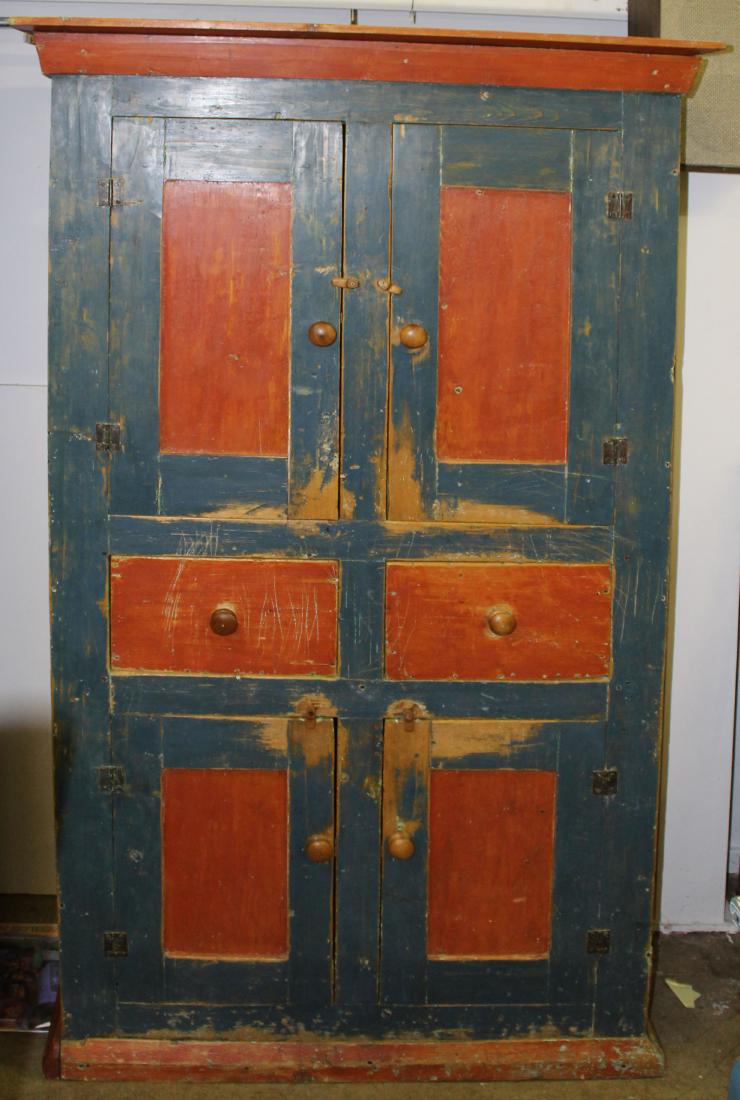 19th c pine wall cupboard: 19th c pine red and blue painted wall cupboard having two paneled doors on two drawers over two paneled doors. 82"h x 41"w x 19"d
