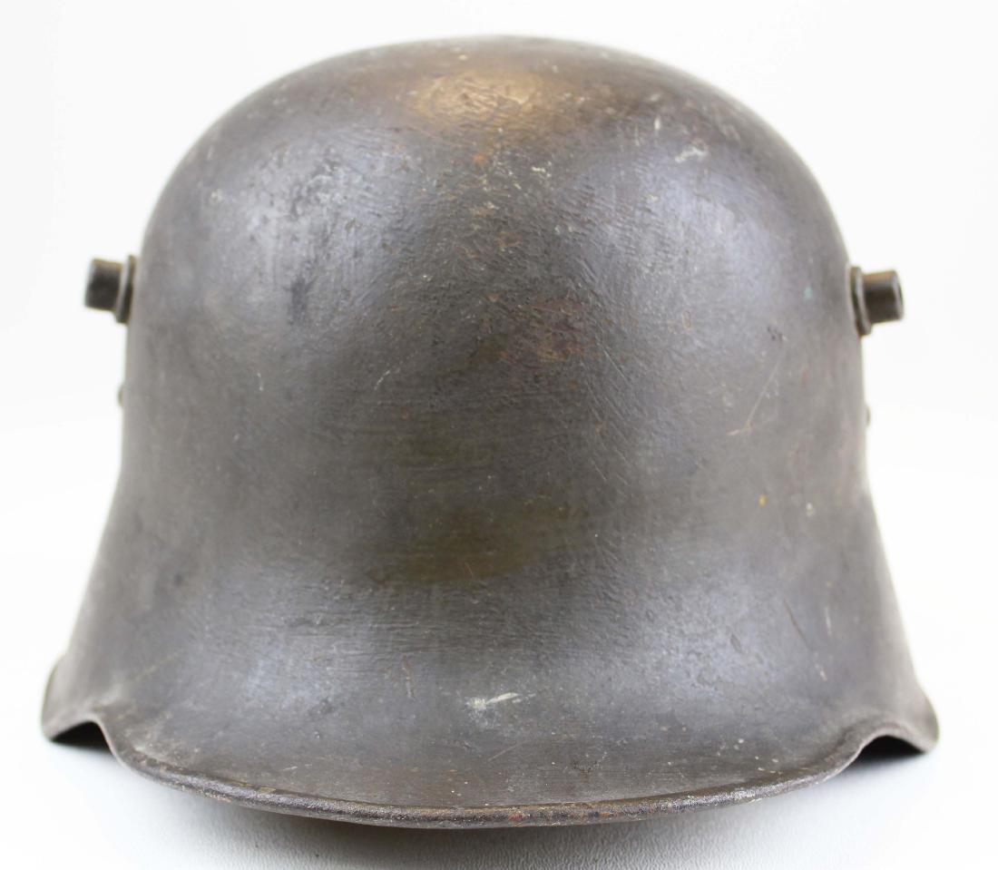 WWI German M18 combat trench helmet: WWI Imperial German M18 combat trench helmet, owned by Austrian Rudolph Mattesich, retains two of the three original leather pads, the third an old in-the-field replacement, has chinstrap