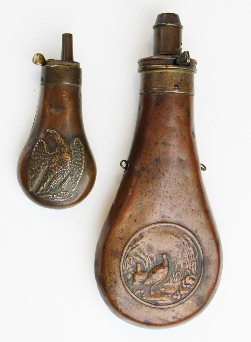 19th c brass powder, pistol flasks: 19th c brass powder flask, 19th c brass pistol flask (Remington?) , both with dents, lengths 4 1/4", 8"