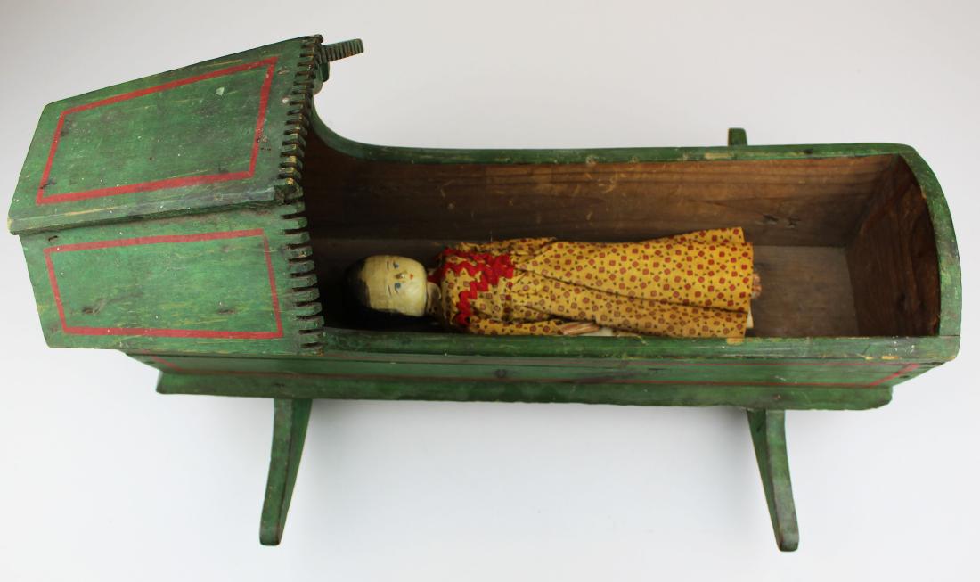 early 19th c painted doll cradle with doll: early 19th c paint decorated doll cradle with penny wooden doll, overall length of cradle 21"