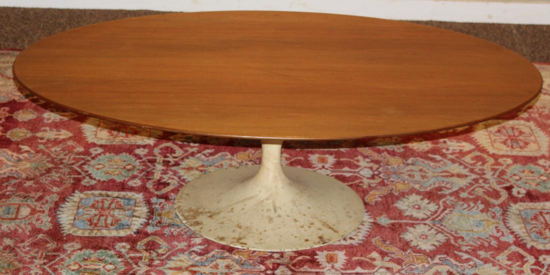 Knoll Saarinen Coffee Table: Knoll Saarinen coffee table with walnut top and tulip form base, some losses to paint on base 53 x 34