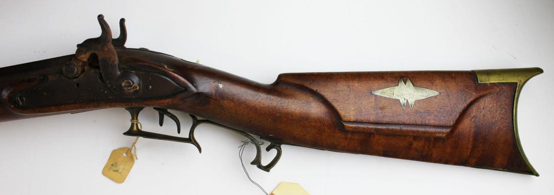 24 gauge percussion shotgun: Rare American 24 ga double barrel percussion shot gun having a figured maple rifle stock, inlay cheek rest and forearm cap of pewter, brass hardware, 3.5" wood chip right forearm, left side crack in f