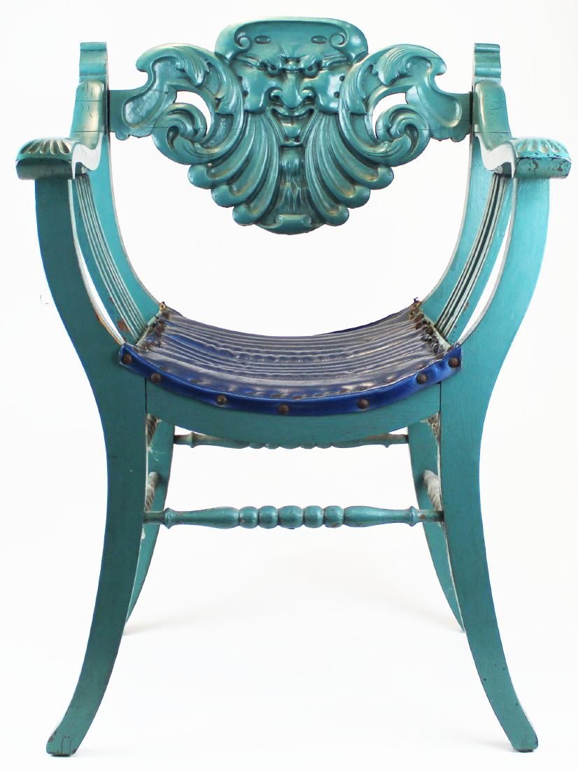 late Victorian carved north wind head chair: late Victorian Renaissance revival style grotesque Northwind head carved figural back curule parlor chair in later blue-green paint with vinyl upholstered seat 36" x 23.5" x 18"