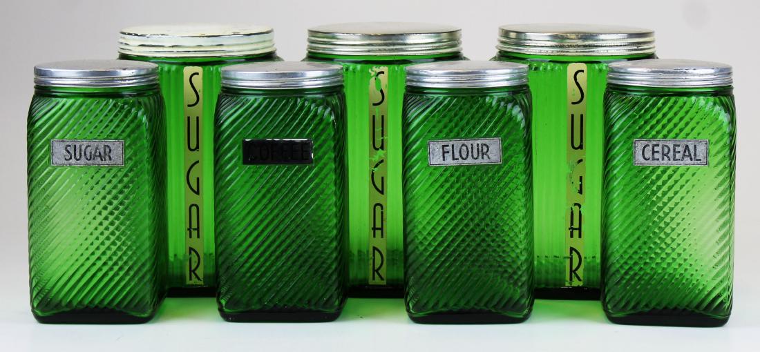 8 pc. 1920's emerald green glass cannister set: 8 pc. Ca. 1920's emerald green ribbed glass cannister set, likely for a Hoosier style baker's cabinet ht. 7", 8"