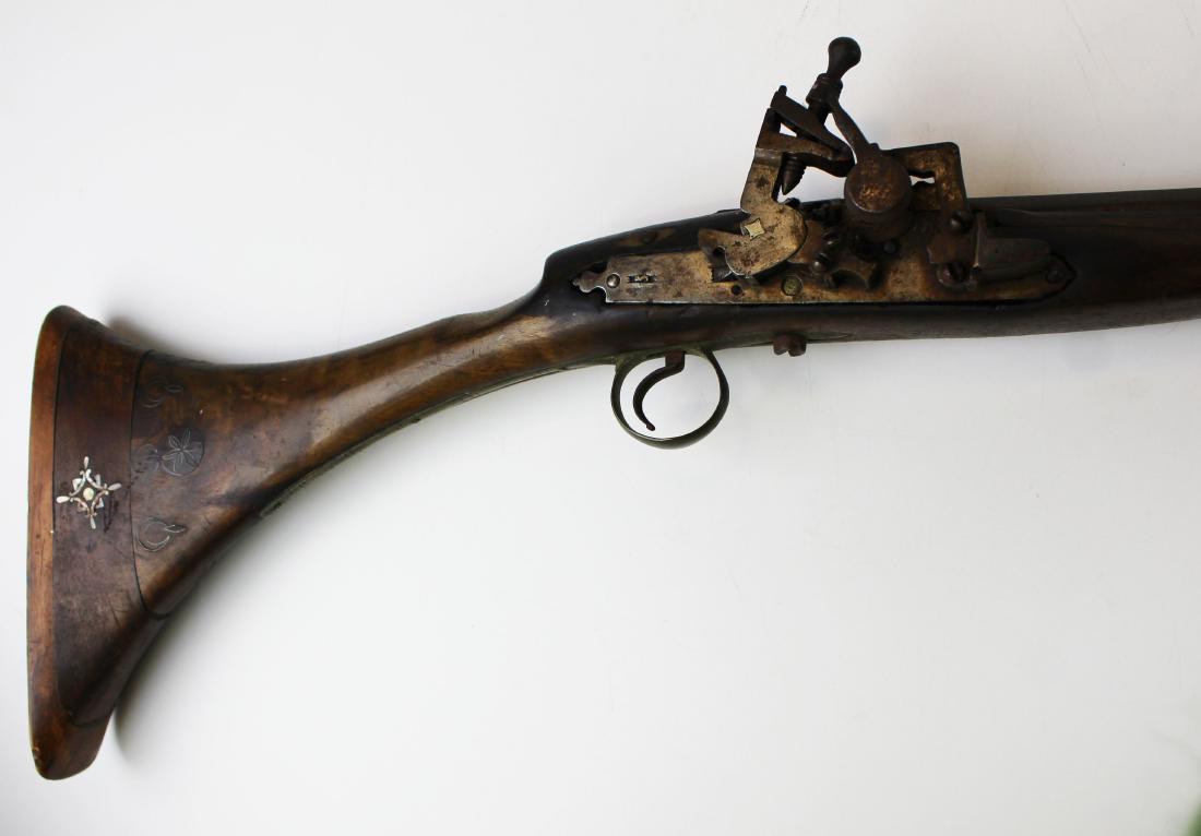 19th c Arabian Jezail Migulet lock musket: 19th c Arabian Jezail musket with Migulet lock, silver inlaid armorer's marks on barrel, silver string inlay calligraphy on stock, other mother of pearl & silver string inlay, overall length 65"