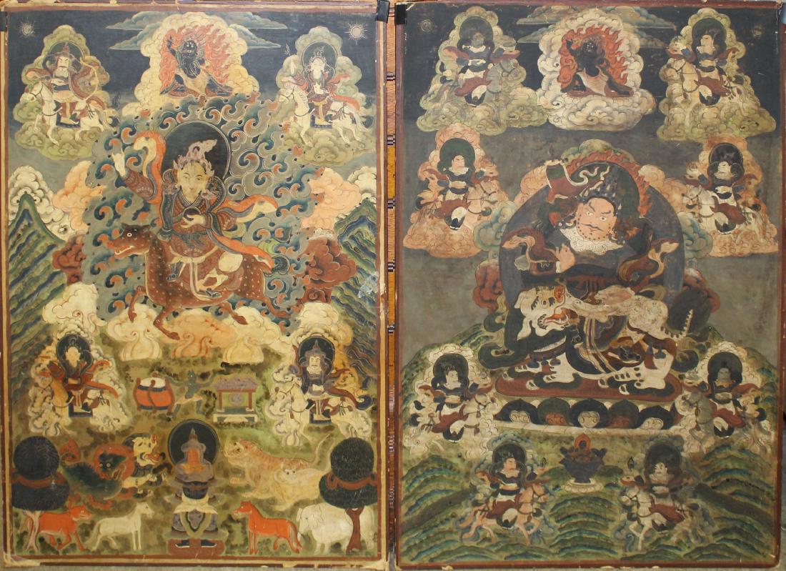 two early 20th c Tibetan Thangkas: two early 20th c Tibetan Thangkas, watercolors on paper, mounted on ca 1930's fiberboard, old framer label A A Munson's Son, New Haven, Conn, smoke stains, 35 1/2" x 25"