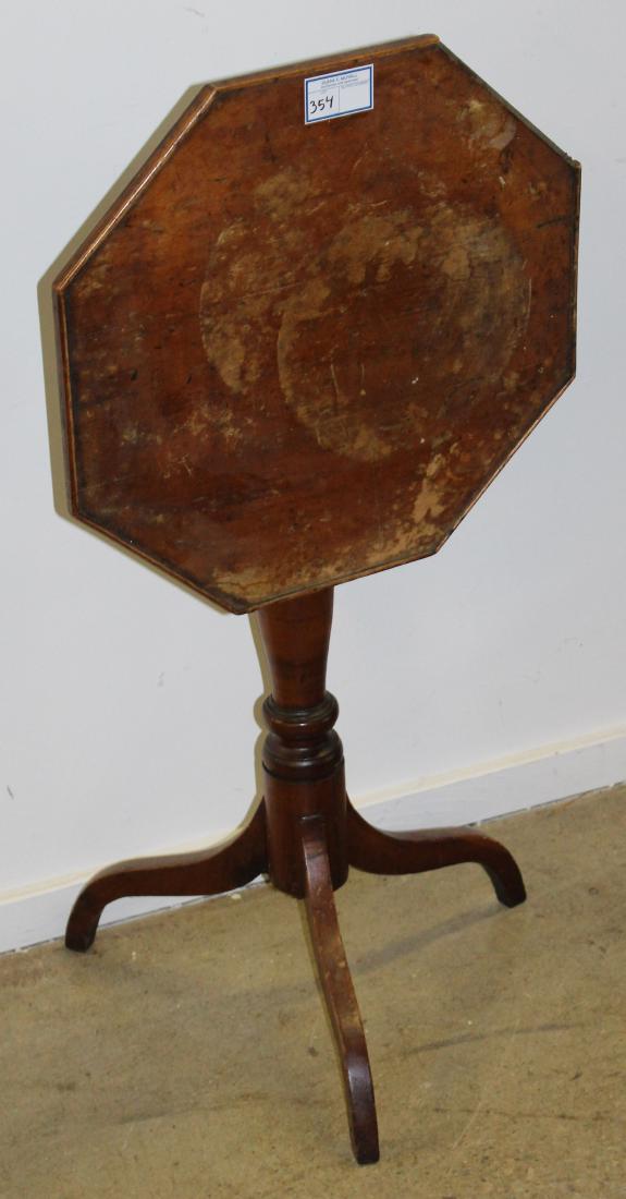 Hepplewhite cherry tilt top candle stand: 19th c. Hepplewhite cherry octagonal tilt top spider leg candle stand with vase form column in older surface, some staining, missing one section of edge molding