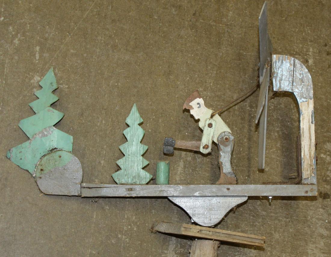 Whirly gig with lumber jack: Early 20th c whirly gig of lumber jack chopping fire wood and trees. Mounted to old cedar fence post. Original paint decoration.
