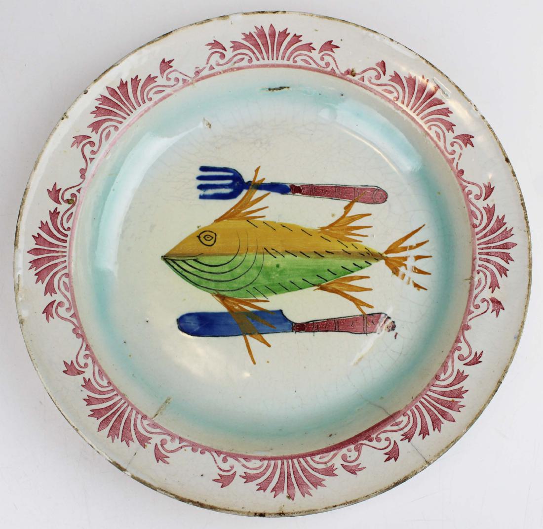 18th c. French tin glazed faience bowl with fish: 18th c. French tin glazed faience pottery seafood serving bowl with salmon colored stenciled border and fish decorated center flanked by fork and knife, hairline check to rim with old staple repair 11