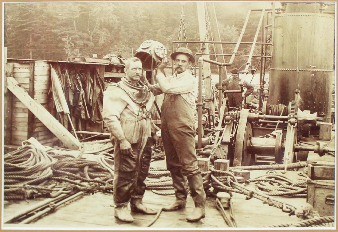 ca 1890 photograph of bell helmet diver: ca 1890 photograph of a diver with a bell helmet on the deck of a ship, image size 5 1/2" x 8"